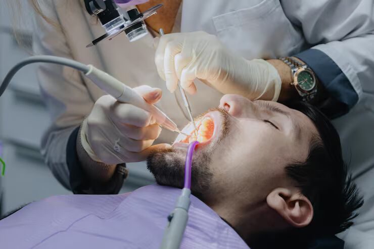 Dentist performing root canal Therapy
